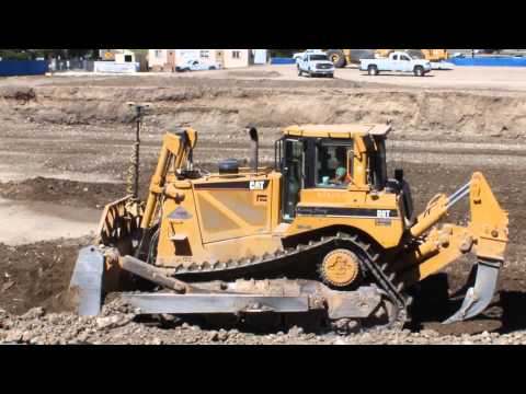 CAT D8T Bulldozer moving dirt on a new school construction site