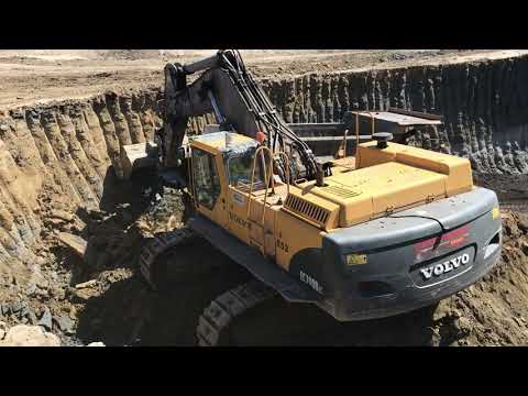 Volvo EC700BLC Excavator Loading Caterpillar Dumpers