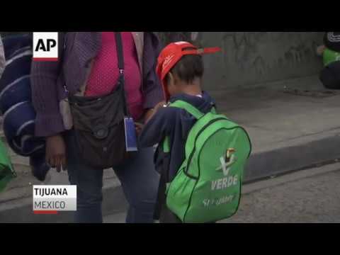 More buses of exhausted people in a caravan of Central American migrants reached the U.S. border Thursday. Migrants crowded Tijuana streets and looked on as officials fortified the border with razor wire and heavily armed agents stood guard. (Nov. 16)