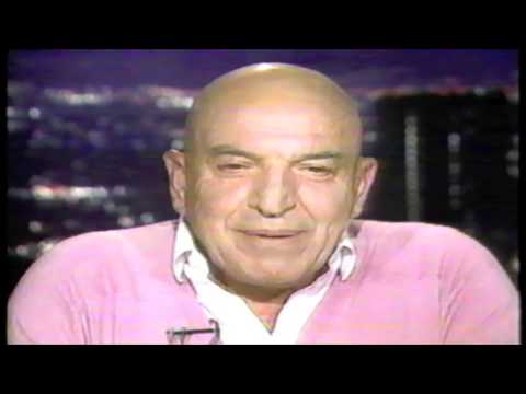 Asking Telly Savalas a question on Larry King