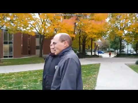 College President confronted and turns away from victim.