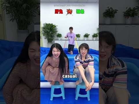 Two friends sit on stools waiting to see who gets dunked in the water.