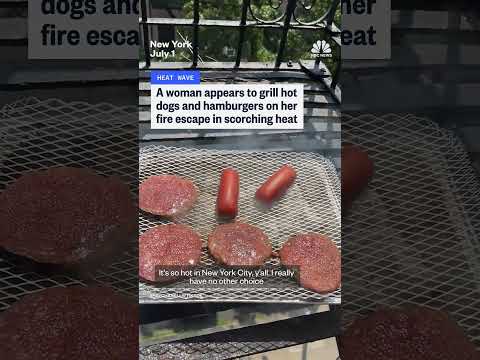 Woman grills hot dogs and hamburgers on her NYC fire escape