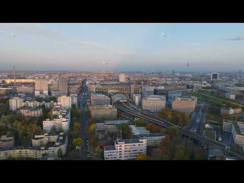 Aerial panoramic view of autumn metropolis at dusk. S Bahn train leaving modern Berlin Hauptbahnhof
