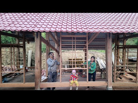 An and the carpenter worked together to design and build wooden window frames for the new log cabin.