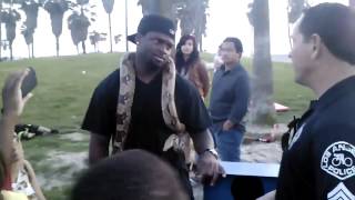 Man with snake round his neck owns cop ike a BOSS!!!