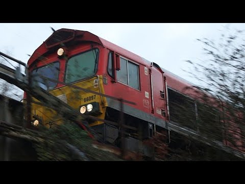 DB class 66097 and DB 66095 In EWS livery pass Neath swing bridge 12/01/23