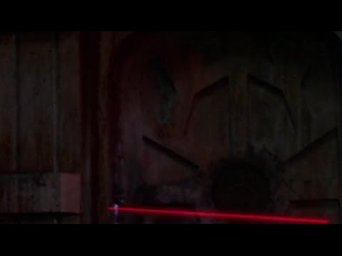 Han Solo blasts at the trash compactor door