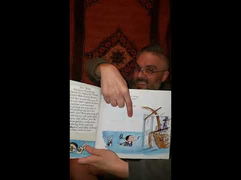 Mr. Greg reads, "That Rabbit Belongs to Emily Brown."