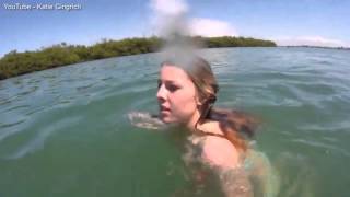 It's more scared of you! Girl on Spring Break freaks out when a harmless - but giant - manatee swim