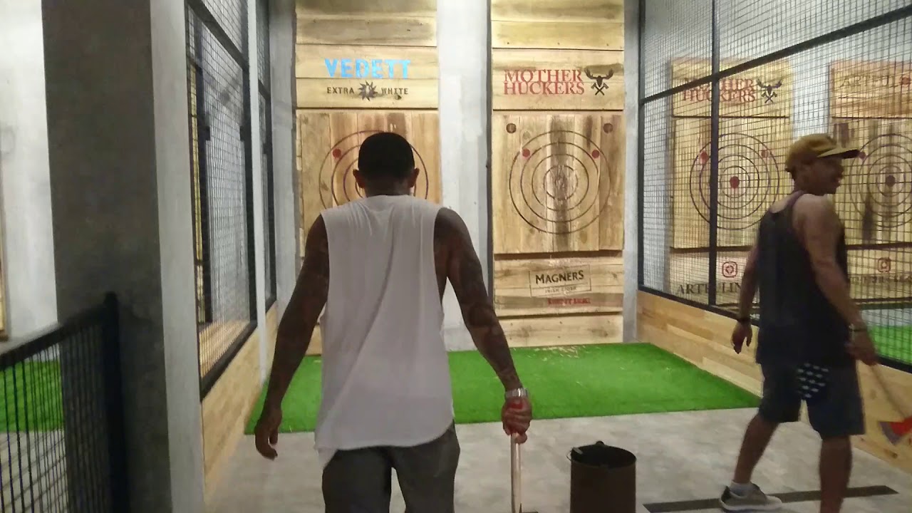 Discover a captivating glimpse of axe throwing at Mother Huckers Club.