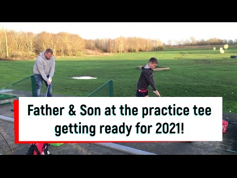 Golf Practice Range Tee - Father and Son practice their long club shots ready for 2021 Season