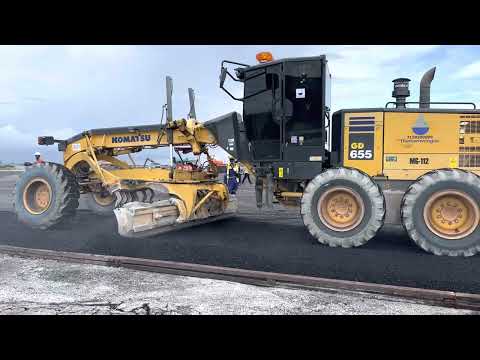 Komatsu motor grader laying asphalt.