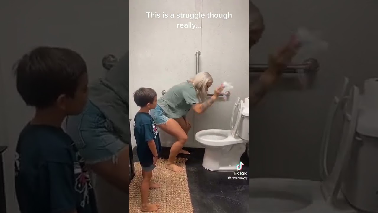 A mother teaching a son how to use the restroom