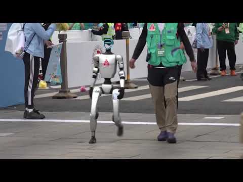 Humanoid Robots Race Humans in a Half Marathon