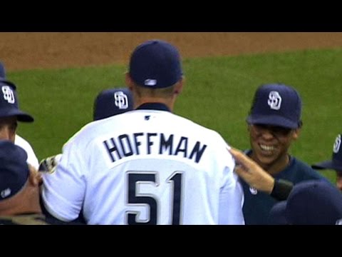 Former San Diego Padres pitcher Trevor Hoffman stands between his wife, Tracy, and one of his sons as he looks at a standing ovation by fans during his induction into the Padres