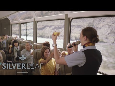 Guide speaking into microphone in front of a SilverLeaf Service coach car