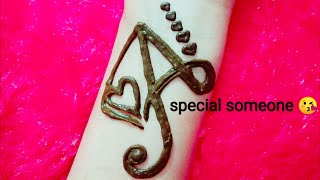 A letter tattoo with heart 💓 mehndi design spec