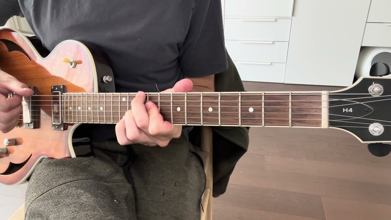 Guitarist demonstrating jazz blues comping with chord voicings rooted on the A string