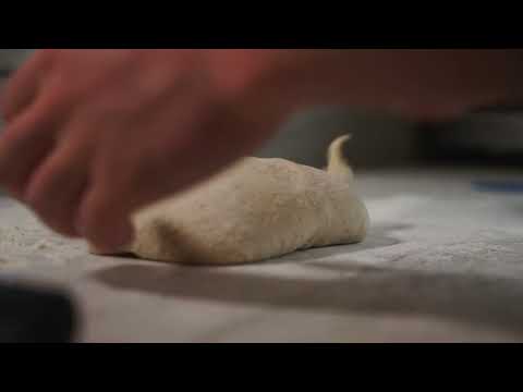 young male chef forming sourdough dough on a kitch 2024 01 22 03 53 32 utc