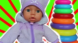 A Fun Doll Named Bongas is Playing with a Multicolored Stacking Rings Baby Toy | Video for kids