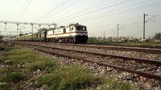 preview picture of video 'Storming WAP-7 Chennai Garib Rath Thrashes WAP-4 Gondwana And Burns Through the Windy Station at MPS'