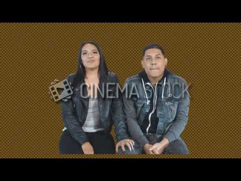 CinemaStock - Greenscreen - Latino couple sitting watching a movie smiling and cuddle