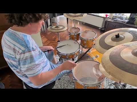Drumming a funk fusion groove on DW Collectors burnt orange glass drums