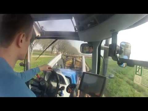 New Holland T7.220 loading and transporting straw