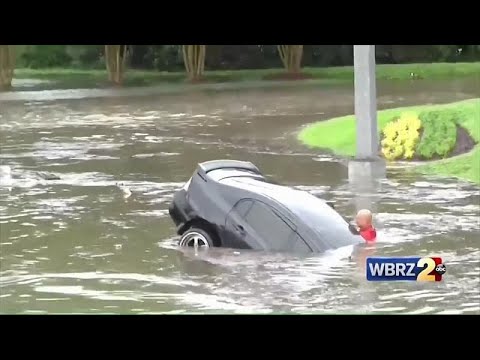 Firefighters save driver after car swept away in flash floods