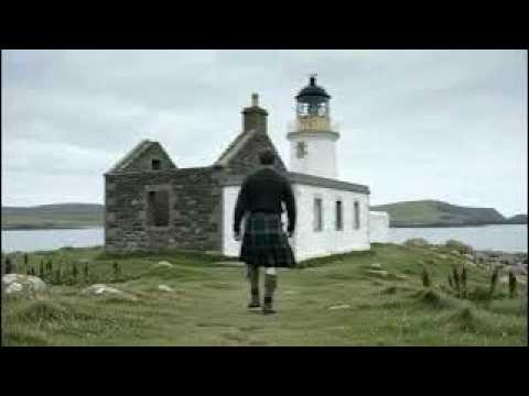 Scotsman Walking Wearing Kilt By Low Lighthouse On History Visit To Isle of May Scotland