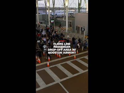 Fliers line passenger drop-off area at Houston airport