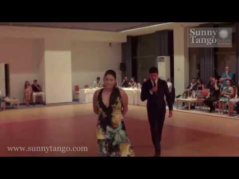  Sebastian Jimenez  and  Maria Ines Bogado  are  dancing  to  the  tango  "  Por Que Regresas Tu  "  by  Carlos di Sarli  at  Sunny Tango Festival  in  2013