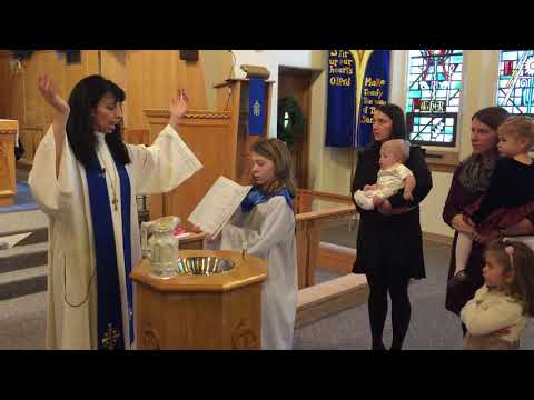 Rev  Niveen baptize a child