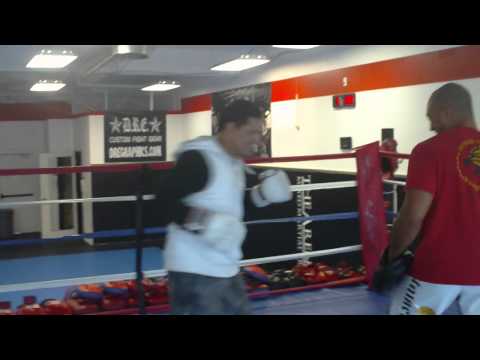 Saulo Ribeiro hitting boxing mitts with Kru Buck Grant at The Arena MMA