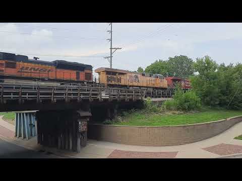 BNSF UP CP lashup passing alongside the vintage switcher in Mankato MN