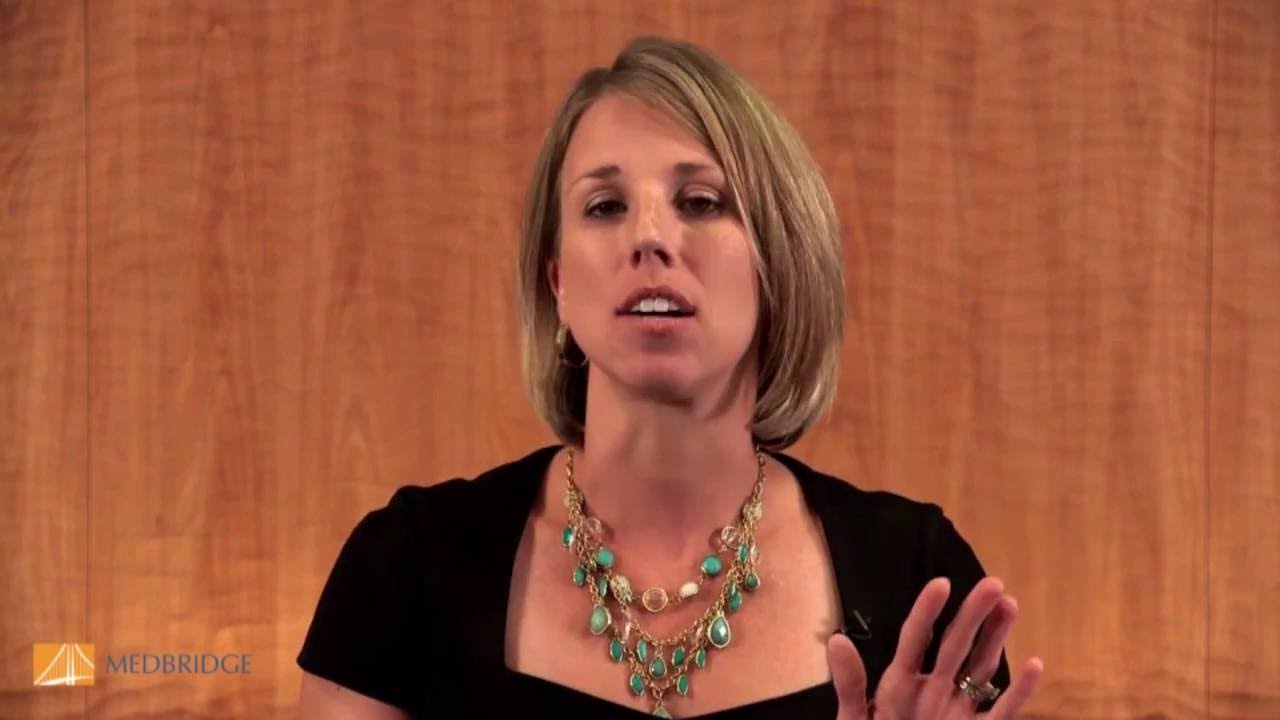 Person with short hair, black top, turquoise necklace discusses Medbridge healthcare education.