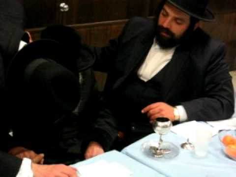 Cup is given to be blessed by Skulener Rebbe