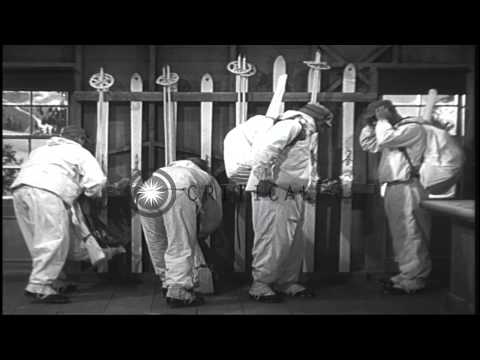 Ski troopers carry rucksacks, apply sun burn lotion and leave an equipment room i...HD Stock Footage