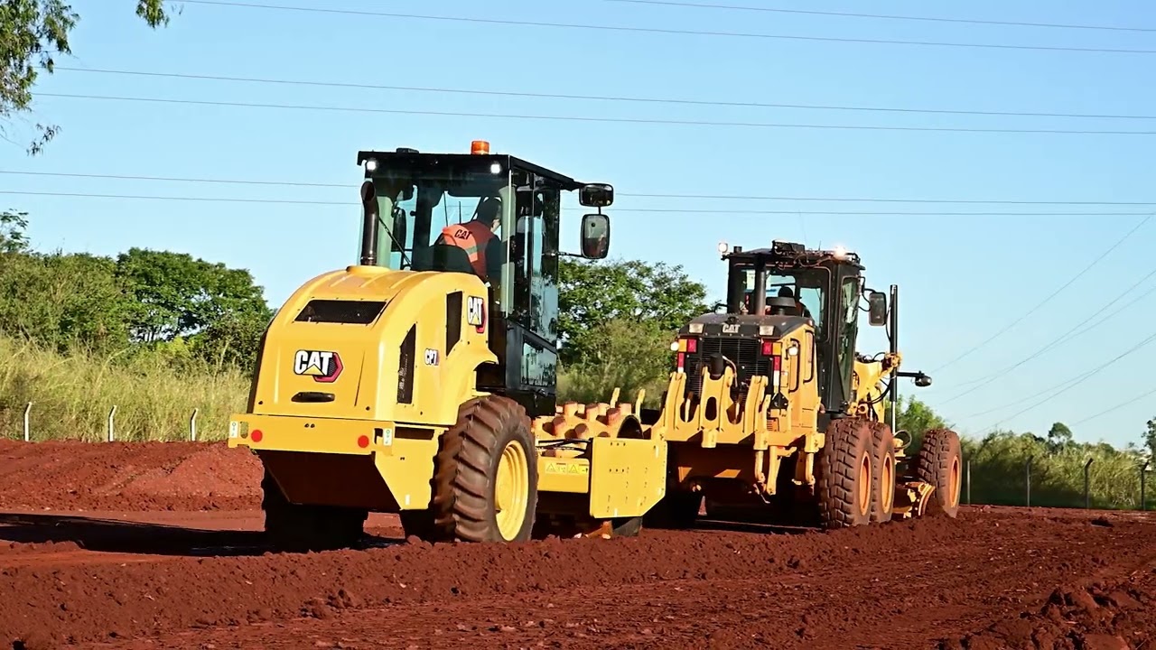 Cat CP7 Padfoot Vibratory Soil Compactor Working Behind a Cat Motor Grader