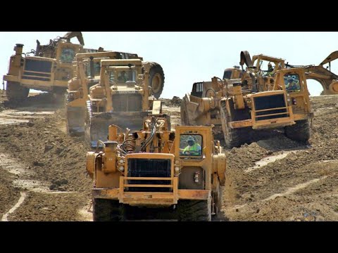 Caterpillar 390D Excavator Loading Mercedes And MAN Trucks.