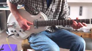 BluesBeaten Redshaw tunes up his new Plasti-Kraft guitar.
