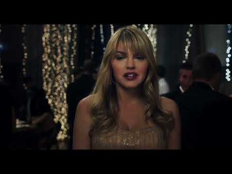 The gym glows in string lights; slow-motion turn as a chorus lifts and the dance begins