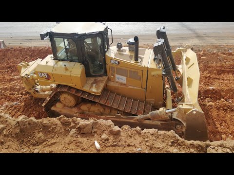 Caterpillar D8 Dozer turning in a very small space whiles Excavator is working close by a busy road