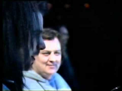 Simon gives Robert a drink....