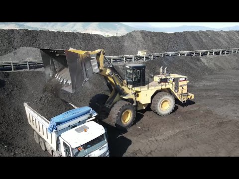Aerial View Of Caterpillar 992G Wheel Loader Loading Coal On Trucks - Sotiriadis/Labrianidis Mining