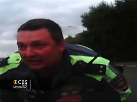 Watch: Russian police officer clings to hood of car