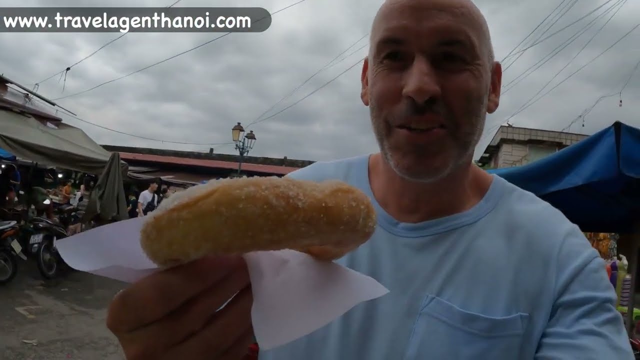 Experience the vibrant atmosphere as tourists explore Hoi An's bustling central market.