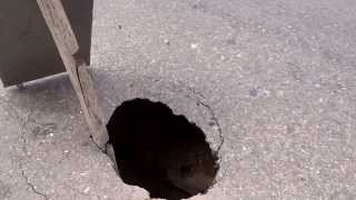 preview picture of video 'Small Road Pothole in Bogotá‎, Colombia, Reveals Large Cavity Beneath (MAH00188)'