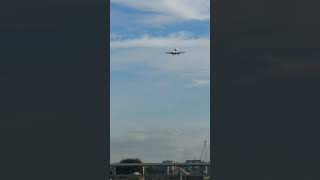 Aeroplane landing over bridge near London City Airport